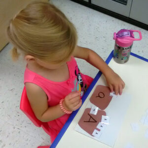 Pre-k student Emma sorting letters