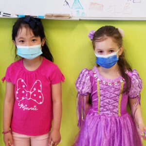 Two pre-k girls play dress up