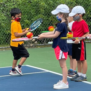 Kids taking tennis lessons