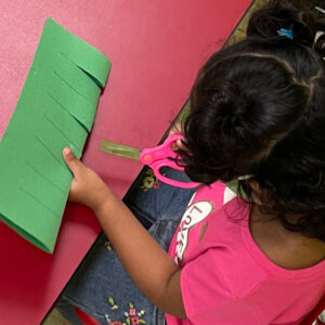 Young girl cutting paper