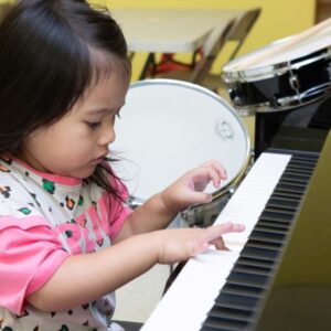Toddler girl playing piano