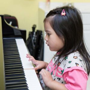 Preschool girl playing piano