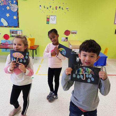 Pre-K kids showing off their artwork