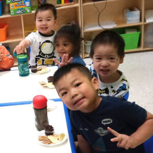 Group of preschool boys take a break from lunch to pose for a photo