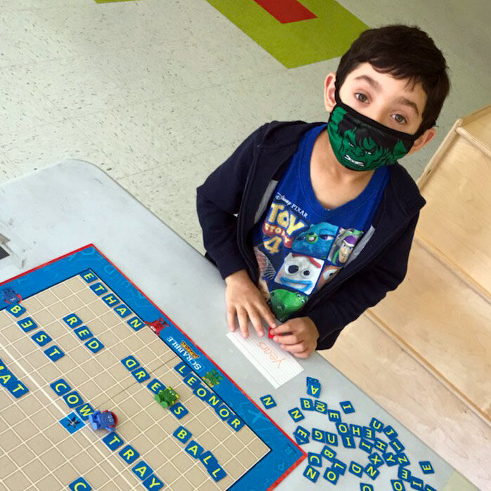 Boy playing scrable after school