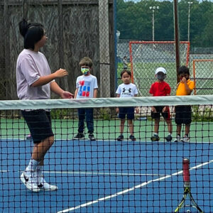 Students learning to play tennis