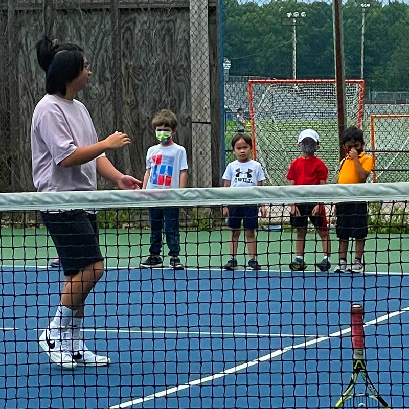 Students learning to play tennis